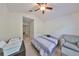 Bright bedroom with bed, chair, and a desk with a printer at 4916 Chatham Gate Dr, Riverview, FL 33578
