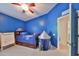 Bright ' bedroom with blue walls, ceiling fan, and a fun play tent at 4916 Chatham Gate Dr, Riverview, FL 33578