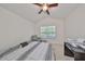 Bright bedroom with vaulted ceiling, ceiling fan, bed, window, and comfortable sitting area at 4916 Chatham Gate Dr, Riverview, FL 33578
