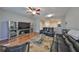 Bright living room features hardwood floors, a ceiling fan, and comfortable seating at 4916 Chatham Gate Dr, Riverview, FL 33578