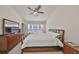 Bright main bedroom features a ceiling fan, large window, and generous closet space at 4916 Chatham Gate Dr, Riverview, FL 33578