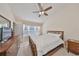 Bright main bedroom features a ceiling fan, large window, and generous closet space at 4916 Chatham Gate Dr, Riverview, FL 33578