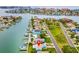 Waterfront home with a dock features an expansive coastal landscape, palm trees, and water access at 525 Lillian Dr, Madeira Beach, FL 33708