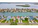 Aerial view of waterfront homes, with boat docks, and a coastal community in the background at 525 Lillian Dr, Madeira Beach, FL 33708