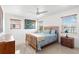 Cozy bedroom featuring a comfortable bed, wooden furniture, natural light, and serene decor at 525 Lillian Dr, Madeira Beach, FL 33708