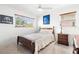 Inviting bedroom with terrazzo floor featuring a bed, window, and ample natural light for a comfortable retreat at 525 Lillian Dr, Madeira Beach, FL 33708