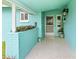 The front entry features terrazzo floors and a teal accent wall, with a planter along the low wall at 525 Lillian Dr, Madeira Beach, FL 33708