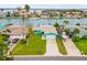 Charming single-story home with a well-manicured lawn and a long driveway at 525 Lillian Dr, Madeira Beach, FL 33708