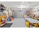 An empty garage with overhead lighting, a large door, and lots of space for storage at 525 Lillian Dr, Madeira Beach, FL 33708