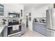 Bright kitchen with white cabinets, stainless steel appliances, and modern countertops at 525 Lillian Dr, Madeira Beach, FL 33708
