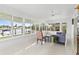 Bright sunroom with floor to ceiling windows overlooking waterfront views at 525 Lillian Dr, Madeira Beach, FL 33708