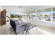 Bright sunroom with large windows offering waterfront views and terrazzo floors at 525 Lillian Dr, Madeira Beach, FL 33708