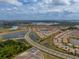 High aerial view showcases this neighborhood, with lakes, roads, and homes with light-colored exteriors at 5329 Windy Grove Dr, Wimauma, FL 33598
