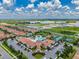 Aerial view showcases a resort-style community, clubhouse, pool, and tennis courts amid lush landscaping at 5329 Windy Grove Dr, Wimauma, FL 33598