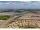 Expansive aerial view of a large residential community featuring multiple lakes, roads and plentiful homes at 5329 Windy Grove Dr, Wimauma, FL 33598