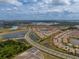 Aerial image showcases a community, with lakes, roads, and single-Gathering homes with light-colored exteriors at 5329 Windy Grove Dr, Wimauma, FL 33598