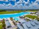 A stunning aerial view of a lagoon community and beach with recreational facilities on a clear sunny day at 5329 Windy Grove Dr, Wimauma, FL 33598