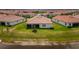 Inviting backyard featuring a screened-in patio, green grass, and a peaceful view at 5329 Windy Grove Dr, Wimauma, FL 33598