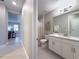 Clean bathroom featuring dual sinks, white cabinets, and a large mirror at 5329 Windy Grove Dr, Wimauma, FL 33598