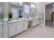 Stylish bathroom featuring double sinks, quartz countertops, and a separate makeup vanity at 5329 Windy Grove Dr, Wimauma, FL 33598