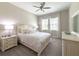 Comfortable bedroom featuring a ceiling fan, neutral paint, and a large window with curtains at 5329 Windy Grove Dr, Wimauma, FL 33598
