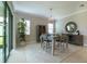 Elegant dining area with a stylish chandelier, a sideboard, and sliding glass doors providing natural light at 5329 Windy Grove Dr, Wimauma, FL 33598