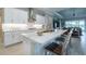 Bright, open-concept kitchen with white cabinets, stainless steel appliances, and a large center island with seating at 5329 Windy Grove Dr, Wimauma, FL 33598