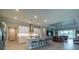 Open-concept kitchen featuring white cabinets, a center island with seating, and seamless flow into the living area at 5329 Windy Grove Dr, Wimauma, FL 33598