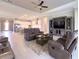 Open-concept living room boasts tile floors, tray ceiling, and is open to the kitchen, perfect for entertaining at 5329 Windy Grove Dr, Wimauma, FL 33598