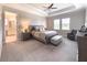 Serene main bedroom suite featuring a plush bed, sitting area, and ensuite bathroom for ultimate relaxation at 5329 Windy Grove Dr, Wimauma, FL 33598