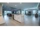 Spacious open-concept living area with tile floors, a modern kitchen island, and a seamless flow to the dining space at 5329 Windy Grove Dr, Wimauma, FL 33598