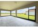Spacious screened-in patio offers serene views of the lake at 5329 Windy Grove Dr, Wimauma, FL 33598