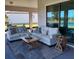 Inviting covered patio featuring comfortable seating, stylish decor, and a serene outdoor ambiance with a view of the lawn at 5329 Windy Grove Dr, Wimauma, FL 33598