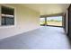 Covered patio overlooking the landscaped yard with a tranquil pond view at 5329 Windy Grove Dr, Wimauma, FL 33598