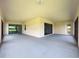 Expansive covered patio offers outdoor living space with sliding glass doors and neutral finishes at 5329 Windy Grove Dr, Wimauma, FL 33598