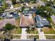 Aerial view of property showcasing well-maintained landscaping, private pool, and proximity to neighborhood at 5921 Denver Ne St, St Petersburg, FL 33703