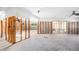 Large living room with sliding glass doors ready for remodeling with exposed framing at 5921 Denver Ne St, St Petersburg, FL 33703