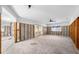 Spacious open-concept living room ready for remodel with exposed framing, white walls, and natural light at 5921 Denver Ne St, St Petersburg, FL 33703