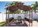 Outdoor grilling station with overhead canopy and prep surfaces situated on brick patio in fenced backyard at 5921 Denver Ne St, St Petersburg, FL 33703