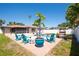 Backyard featuring a pool, patio with seating, and a lush landscape perfect for relaxing and entertaining outdoors at 5921 Denver Ne St, St Petersburg, FL 33703