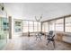 The large sunroom features tile flooring, several windows, and abundant natural light at 5921 Denver Ne St, St Petersburg, FL 33703
