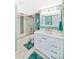 Bright bathroom featuring a modern vanity with a white countertop and stylish tile in the shower at 6035 Sea Ranch Dr # 612, Hudson, FL 34667