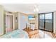 Bright bedroom with balcony, a work station, and coastal accents at 6035 Sea Ranch Dr # 612, Hudson, FL 34667