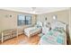 Comfortable bedroom with twin beds, window views and coastal accents at 6035 Sea Ranch Dr # 612, Hudson, FL 34667