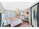 Comfortable bedroom features wood floors, a large closet, and a view into the next room at 6035 Sea Ranch Dr # 612, Hudson, FL 34667