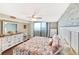 Bright and airy main bedroom with balcony access, a decorative stone wall, and wood flooring at 6035 Sea Ranch Dr # 612, Hudson, FL 34667
