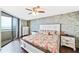 Relaxing main bedroom features a decorative stone wall, wood floors, and a private balcony at 6035 Sea Ranch Dr # 612, Hudson, FL 34667