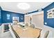 Inviting dining area boasts blue walls, seating for eight, and easy access to the next room at 6035 Sea Ranch Dr # 612, Hudson, FL 34667