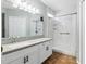 The bright bathroom features a walk-in shower, white vanity, and updated fixtures at 6616 Northhaven Ct, Riverview, FL 33578