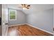 Cozy bedroom featuring stylish wood-look floors and a bright window for natural light at 6616 Northhaven Ct, Riverview, FL 33578